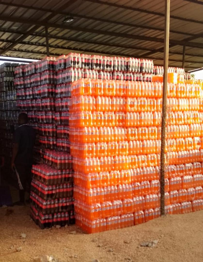 Coca-Cola and Fanta crates stacked in the covered storage shed