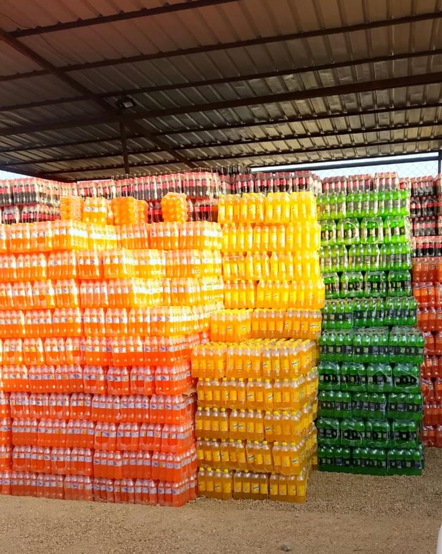 Fanta and Sprite crates stacked in the covered storage shed
