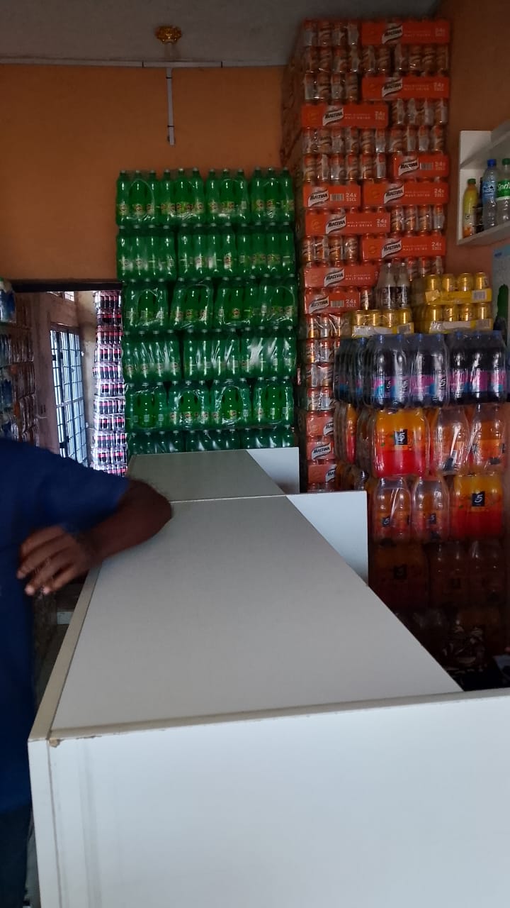 Beverage shelf stocked with Sprite and Maltina at a retail counter